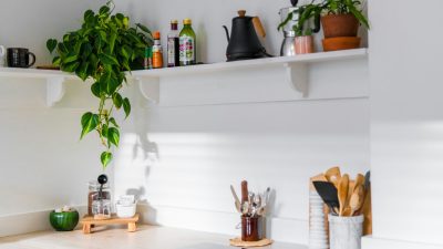 organized small kitchen with labeled storage boxes, hanging racks, and countertop decor — DIY tips to make life easier at home