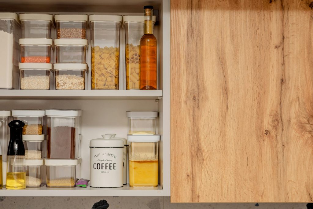 organized kitchen cabinets with labeled storage boxes